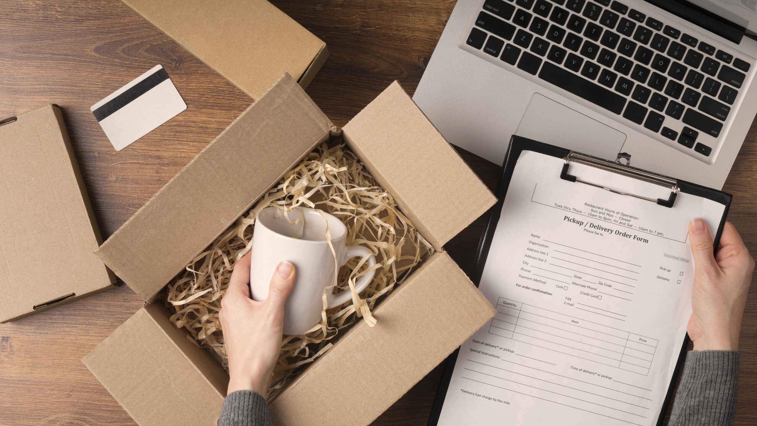 Using a handheld scanner to verify FNSKU labels before boxing for FBA shipment.