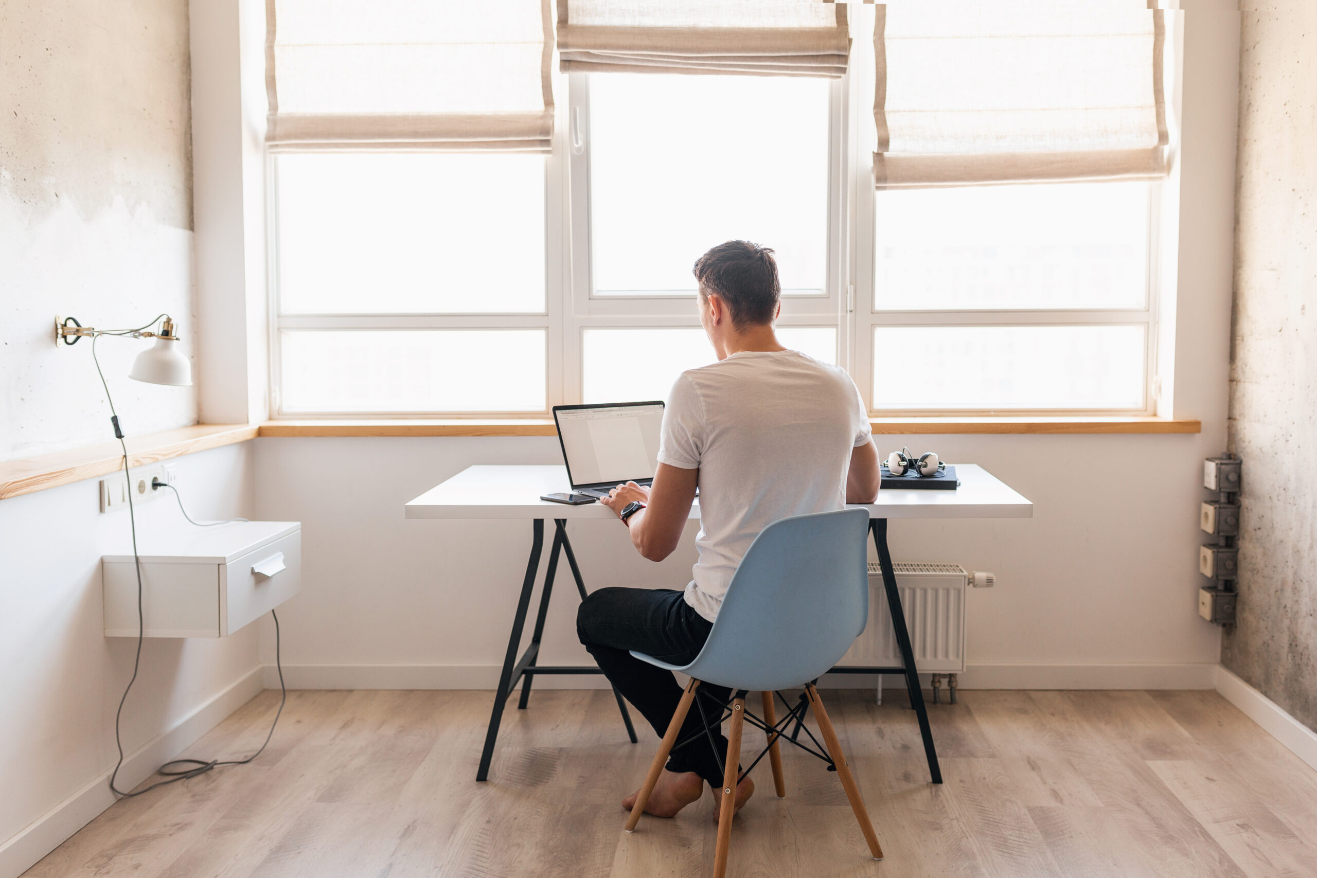 man in casual outfit sitting at table working on planning on delegating task as one of his entrepreneur habits